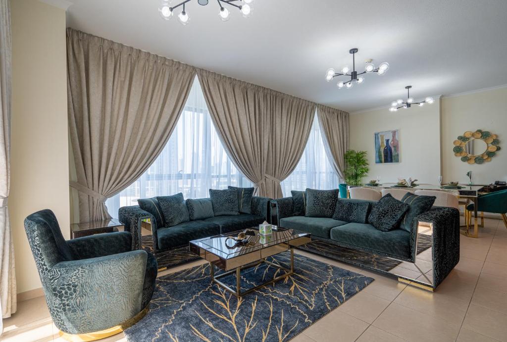 a living room with a couch and chairs and a table at INA HOMES - 2BHK Residences Tower 1 in Dubai