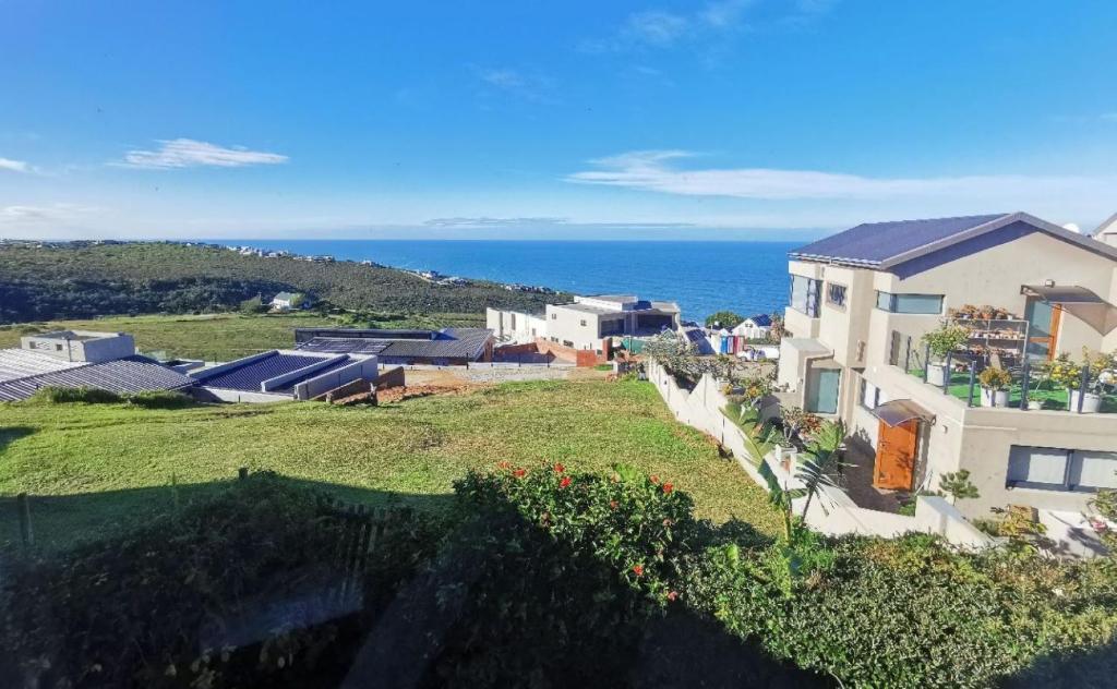 an aerial view of a house with the ocean in the background at BellaBlues in Herolds Bay