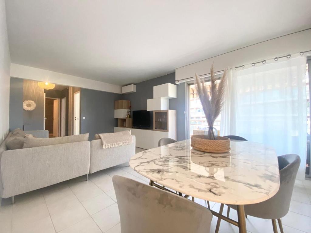 a living room with a table and a couch at Apartment Antibes city-center & port in Antibes