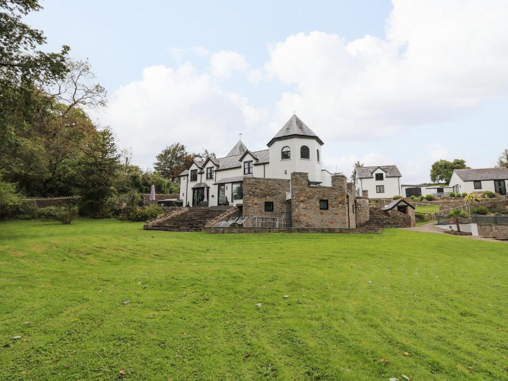 a large house with a green field in front of it at Glamorgan House in Cardiff