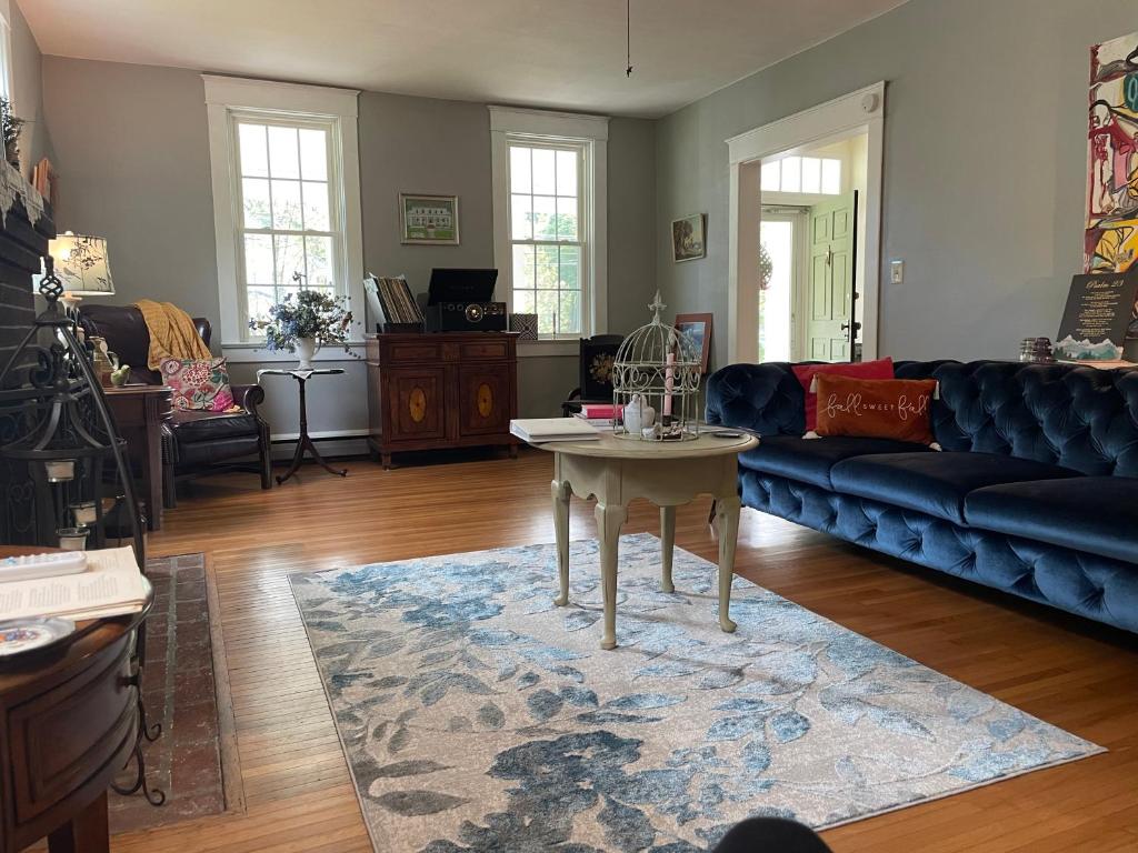 a living room with a couch and a table at Das Gasthaus, The Inn of Claysburg in Claysburg