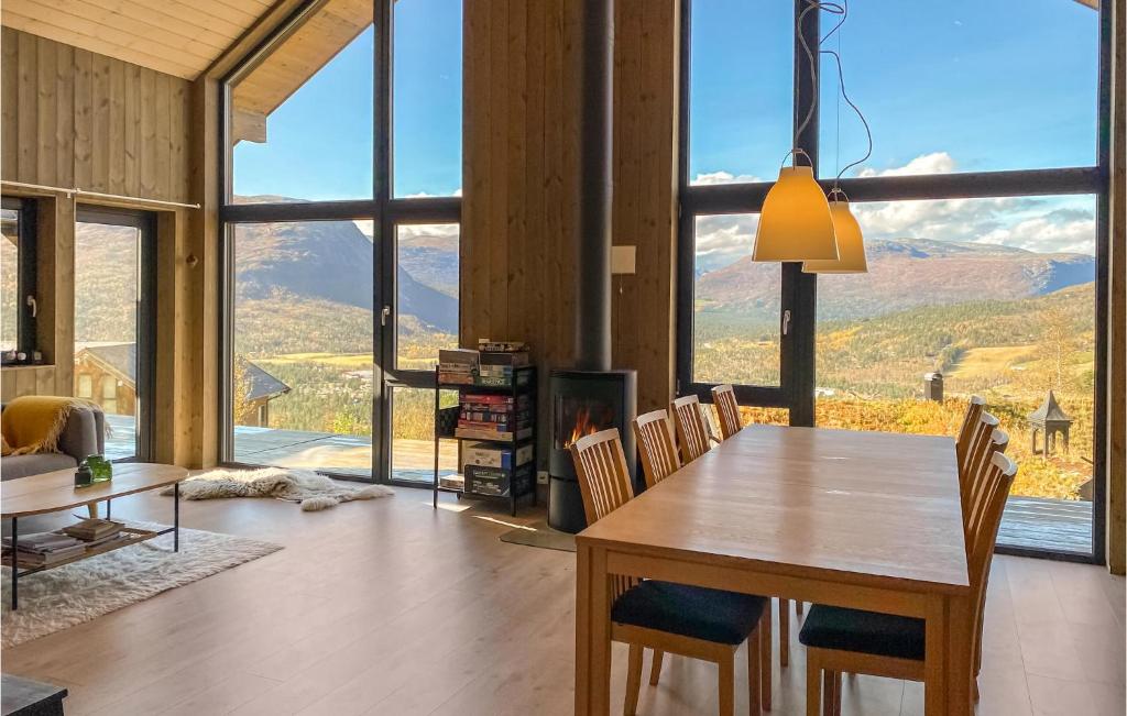 a dining room with a table and chairs with a view at Gorgeous Home In Bjorli With House A Panoramic View in Bjorli