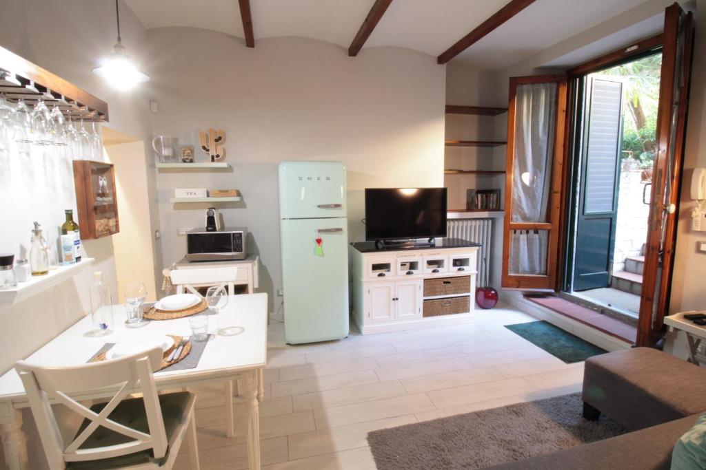 a kitchen with a refrigerator and a table with chairs at Casa Margherita in Florence