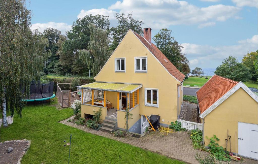 an aerial view of a yellow house with a yard at Beautiful Home In Faaborg With Wifi in Faaborg