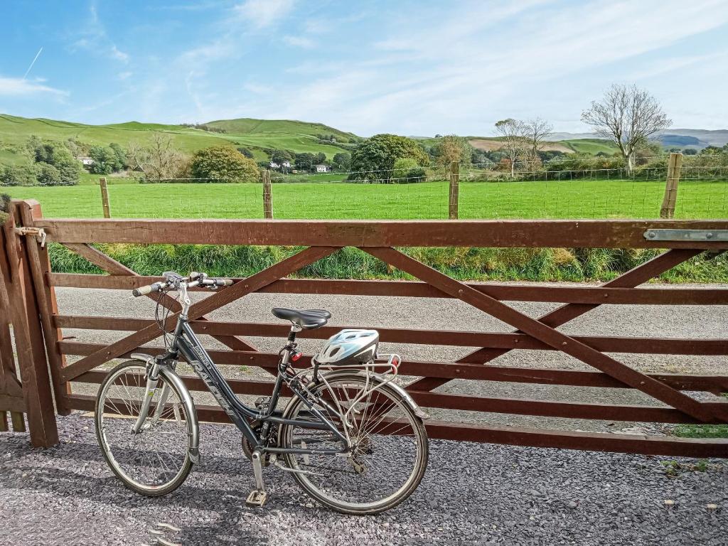 a bike parked next to a wooden fence at Bryntrisant in Devils Bridge