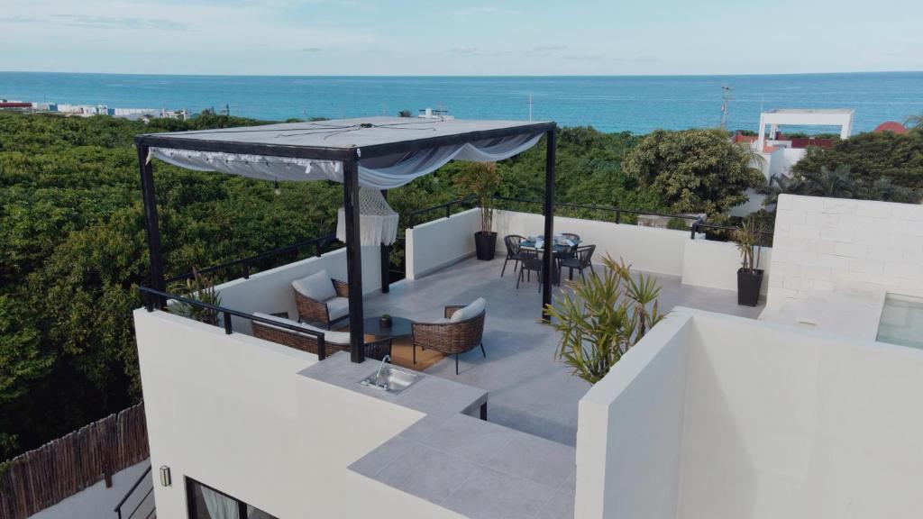 a patio with an umbrella on top of a building at Peaceful Villa W Ocean View Rooftop in Punta Sur in Isla Mujeres
