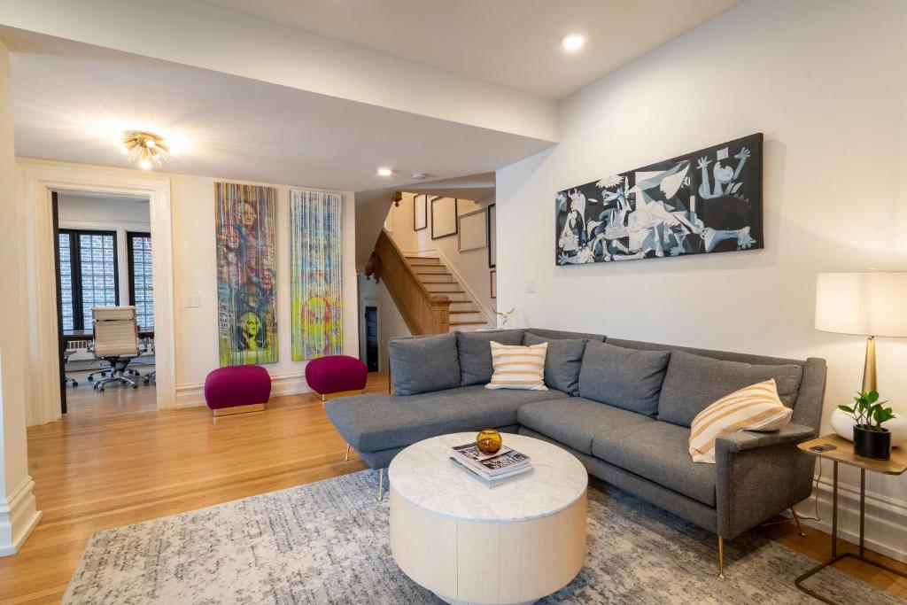 a living room with a couch and a table at The Buckeye Retreat Mansion in Columbus