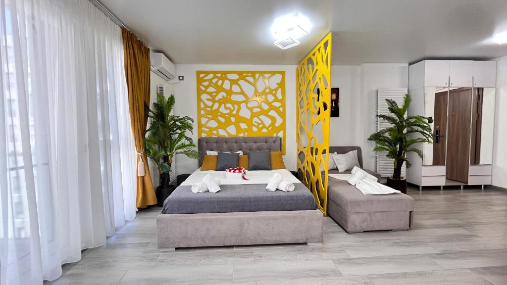 1 dormitorio con 1 cama y 2 sillas en Havana Studio-Alezzi Nord 10 (piscina&loc parcare), en Năvodari