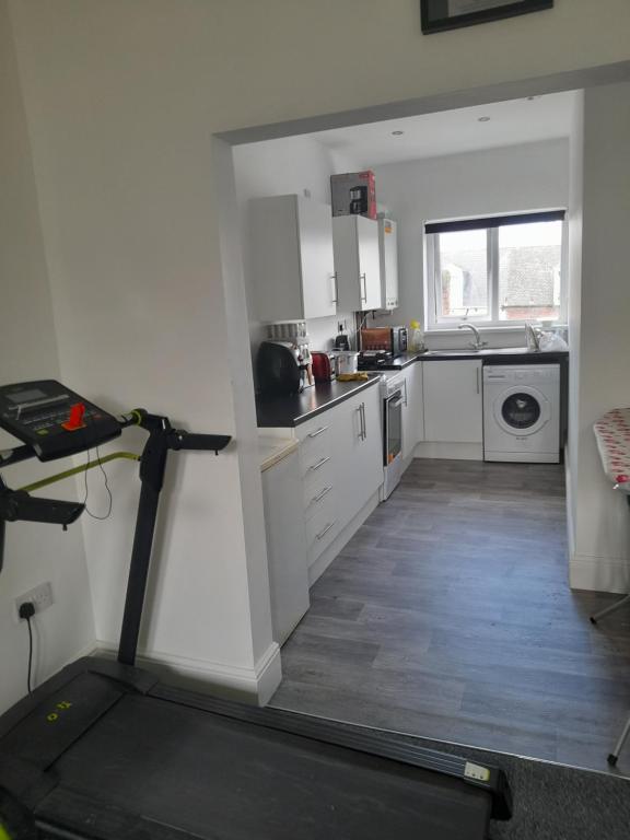 a kitchen with a treadmill in the middle of a room at ACCANE in Monkwearmouth