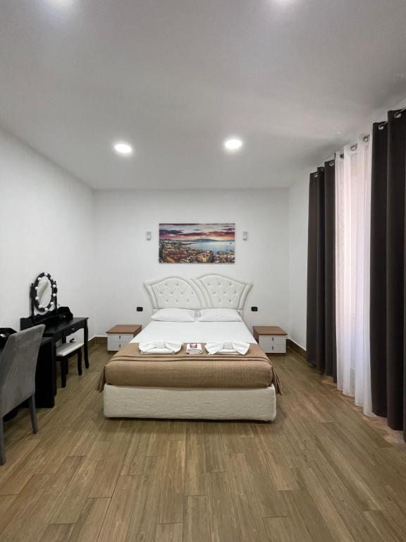 a bedroom with a bed and a desk and a piano at BeB sott o pont Napoli in Naples