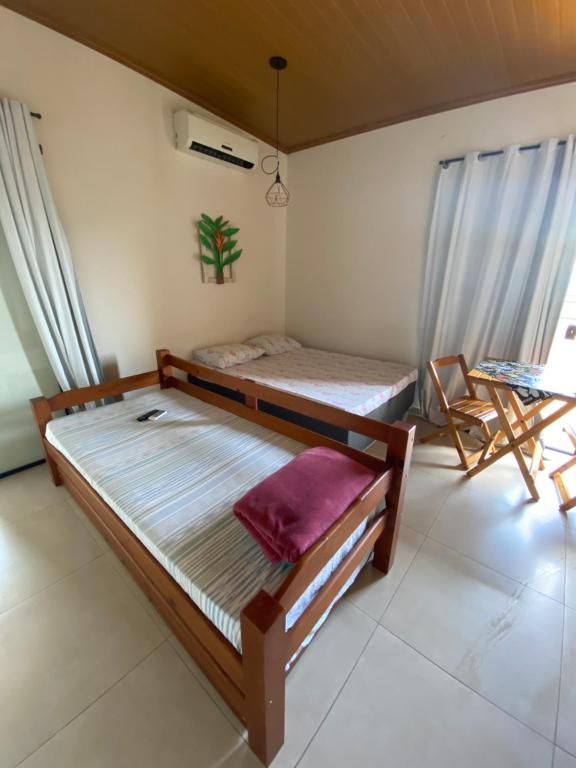 a bedroom with two bunk beds and a table at Residencial Aquidabã in Angra dos Reis