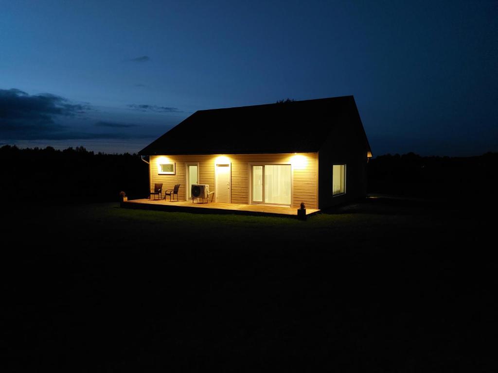 a small house at night with lights on at Oruheina Bungalow 