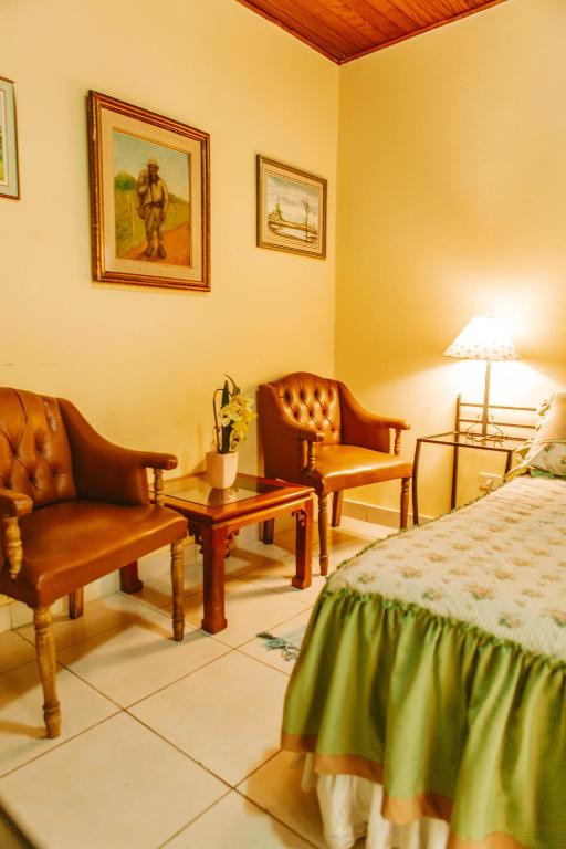 Postel nebo postele na pokoji v ubytování Hotel Santo Domingo