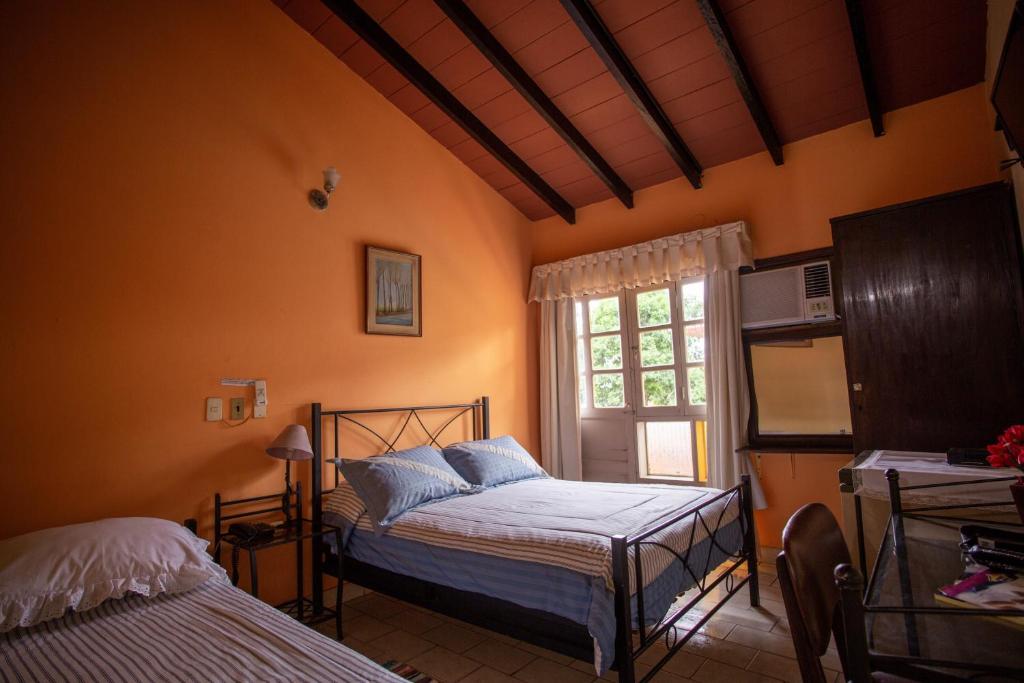 Postel nebo postele na pokoji v ubytování Hotel Santo Domingo