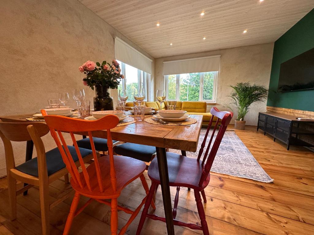 a dining room with a wooden table and chairs at Magical two bedroom apartment in Viljandi in Viljandi