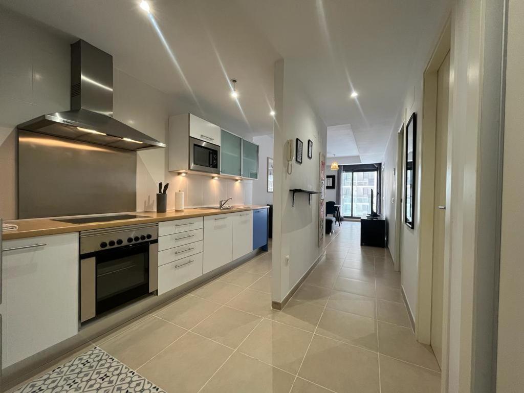 a large kitchen with white appliances and a hallway at Cala Alta Sea Dreams in Benidorm