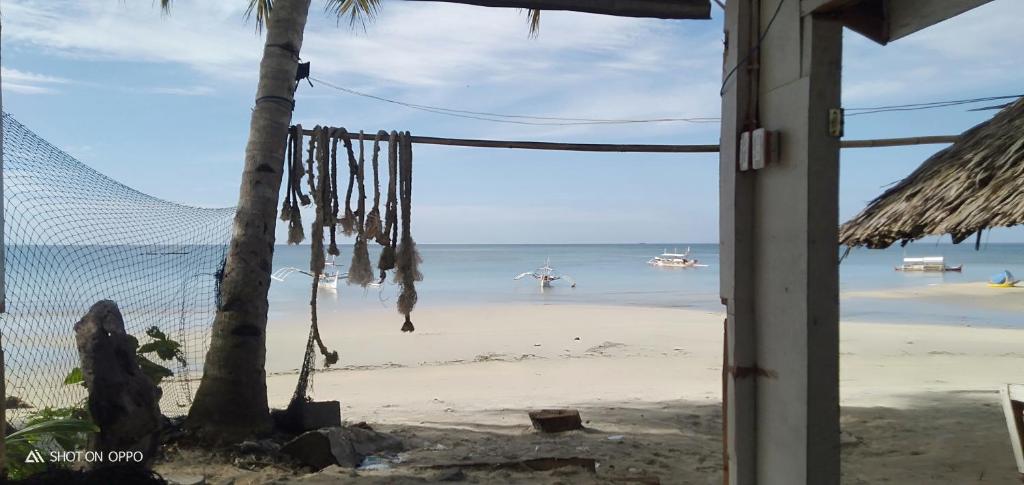 a view of the beach from a beach house window at beach Housenice view beach in Mananda