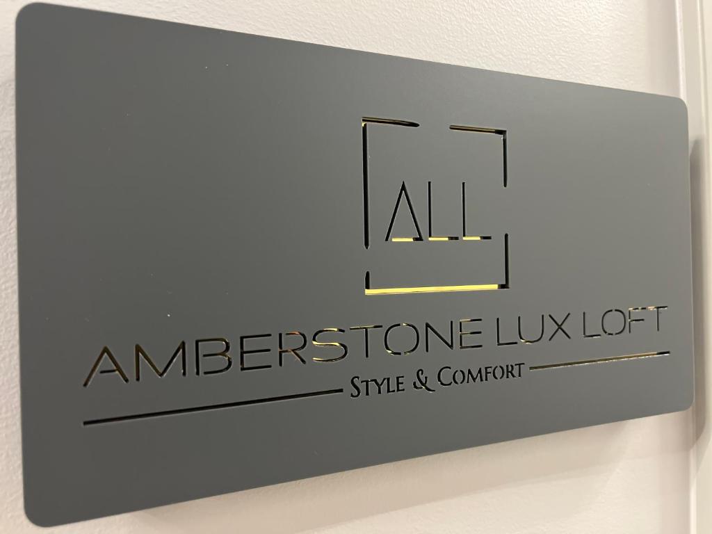 a sign that reads americstone luxot on a wall at ALL - Amberstone Lux Loft in Klaipėda