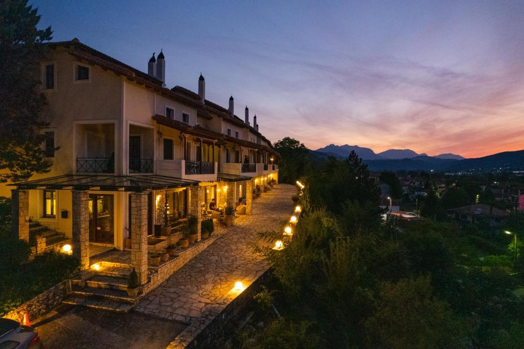 a view of a building with lights at night at Archontiko Zafeiropoulou in Kalavrita