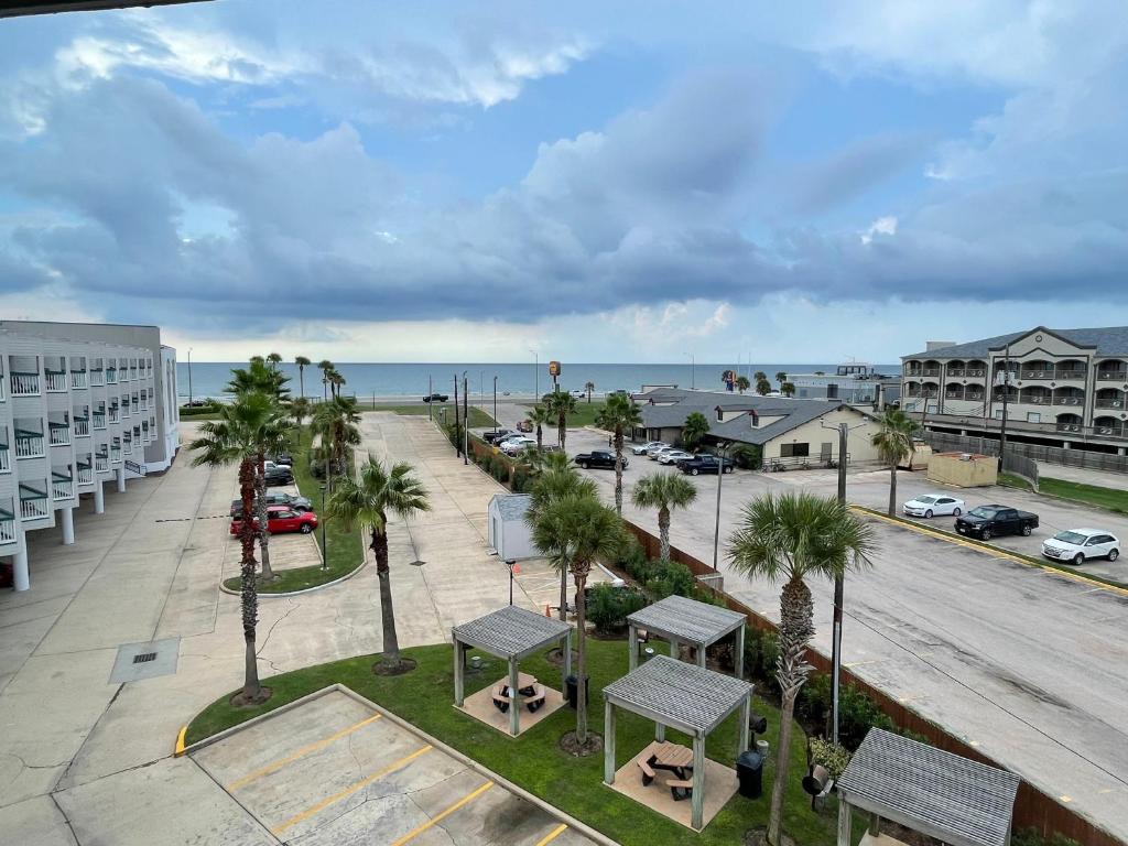 a view of a street with palm trees and a parking lot at Casa Del Mar Sun Diamond One Bedroom Retreat - Galveston in Galveston