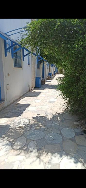 un callejón vacío con un edificio azul y blanco en good vacation en Houmt El Souk