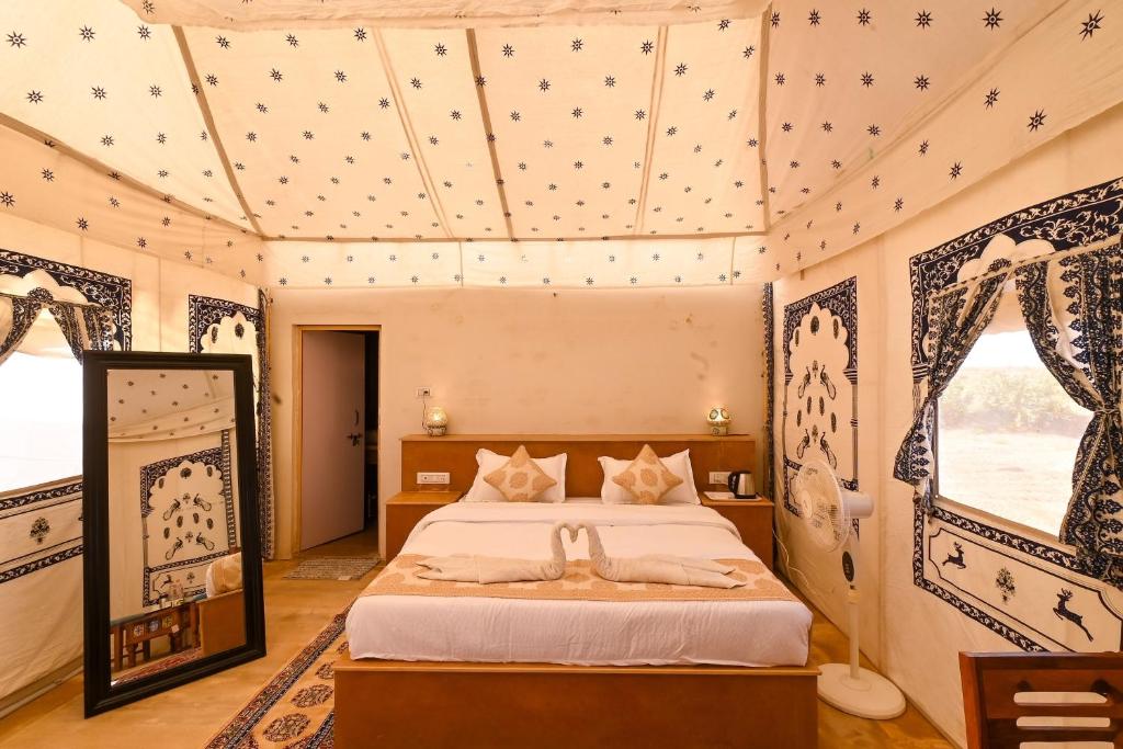 a bedroom with a bed in a room at Shrinath Desert Camp in Jaisalmer