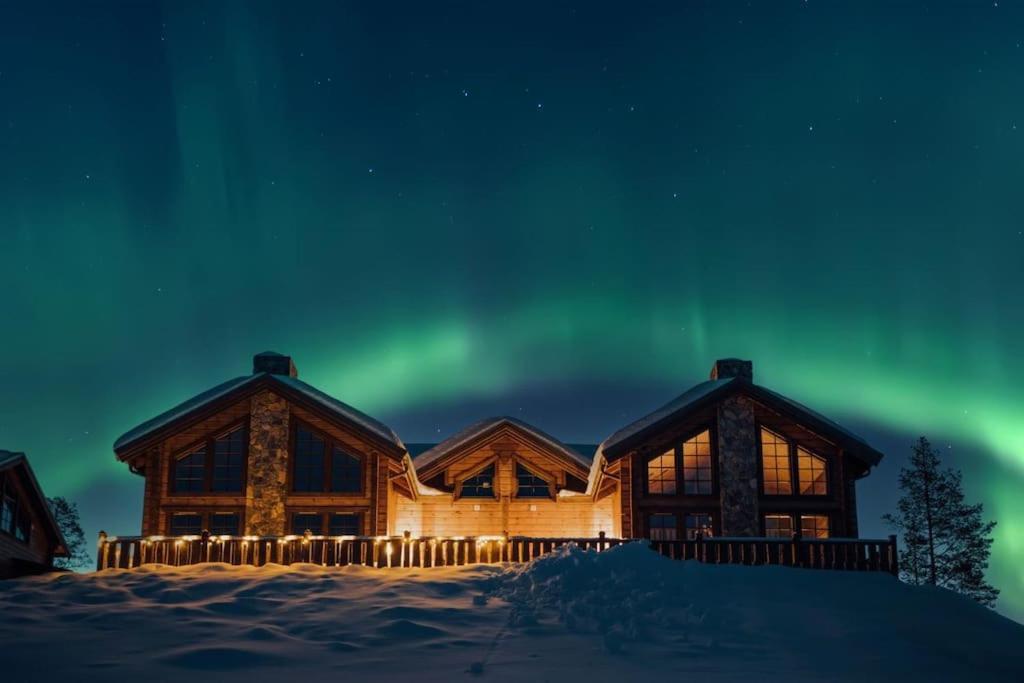 a log cabin with the aurora in the sky at Idre Mountain Lodge dream with outdoor Jacuzzi ! in Idre