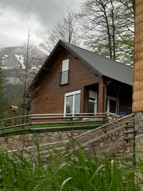 a house on a hill with mountains in the background at Villa Pax in Peje