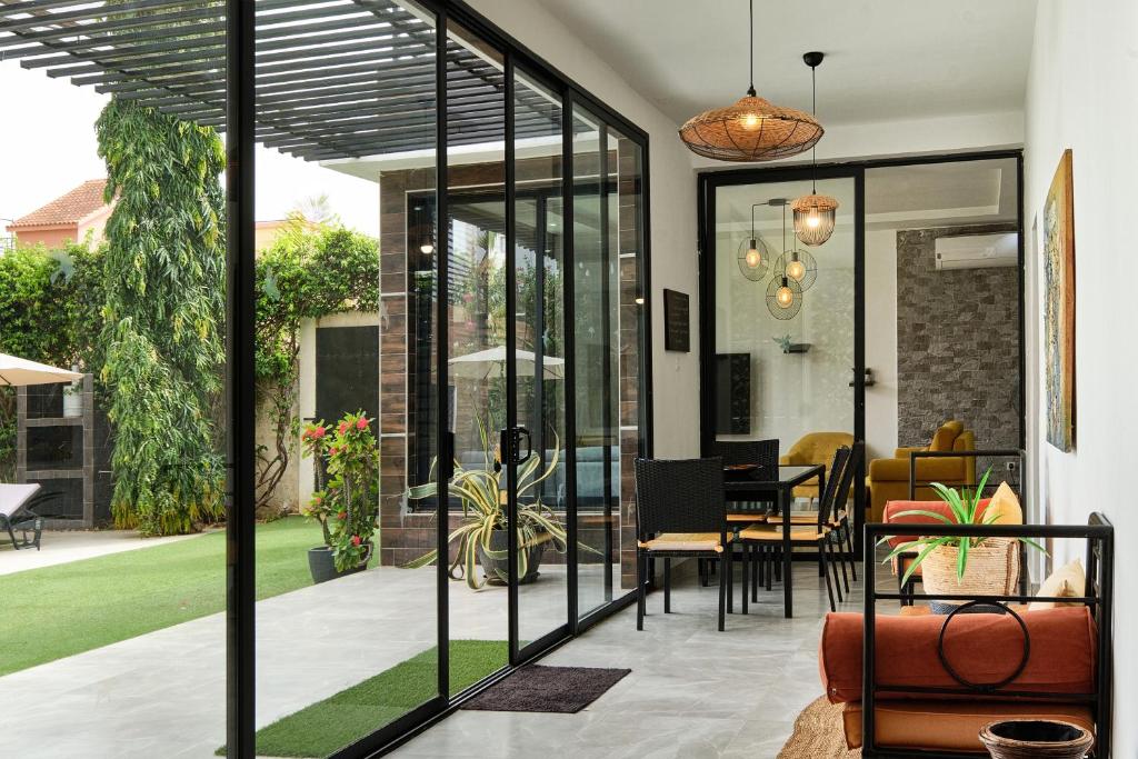 a glass extension of a house with a dining room at Villa Umy in Ngaparou