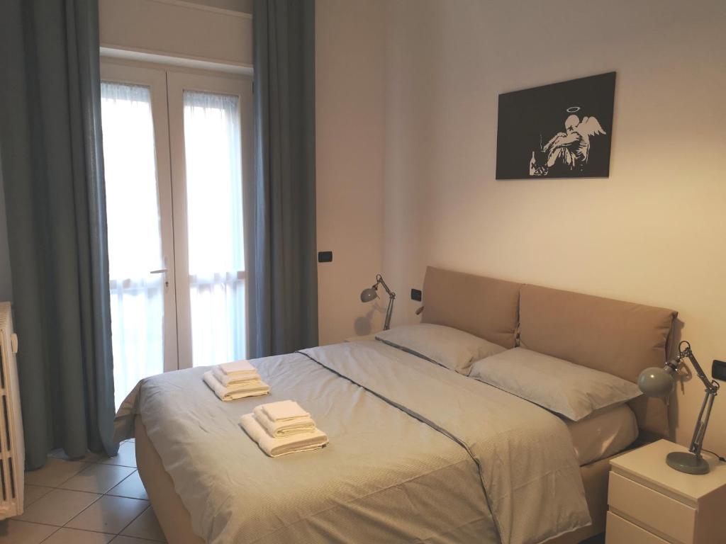 Letto o letti in una camera di Holiday Apartment - Brescia centro - PARCHEGGIO PRIVATO