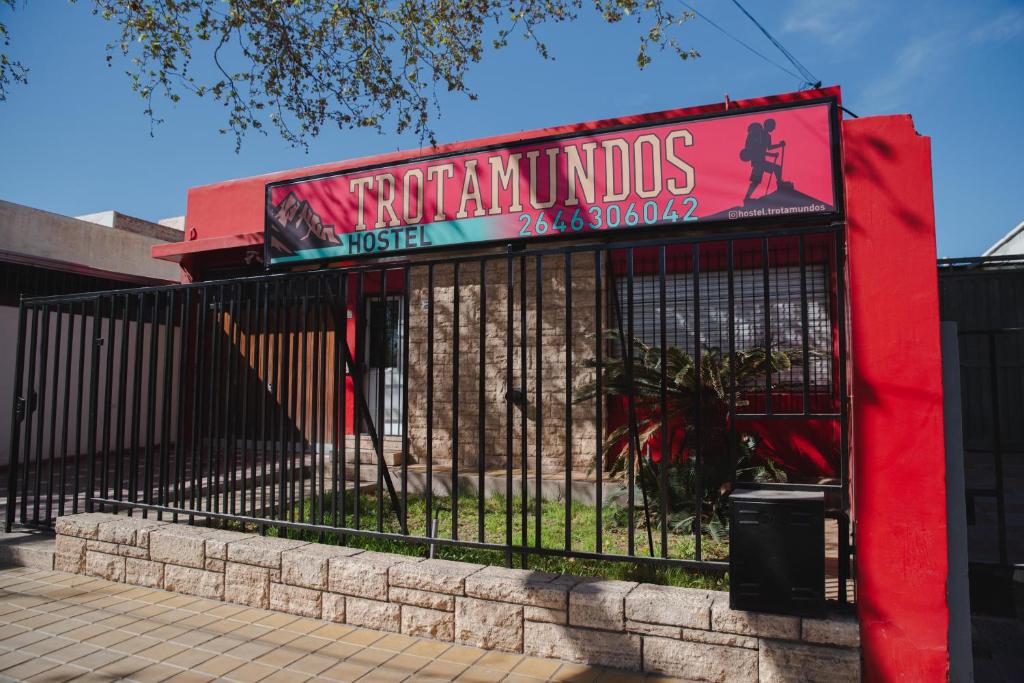 a black fence with a sign on it at Hostel Trotamundos in San Juan