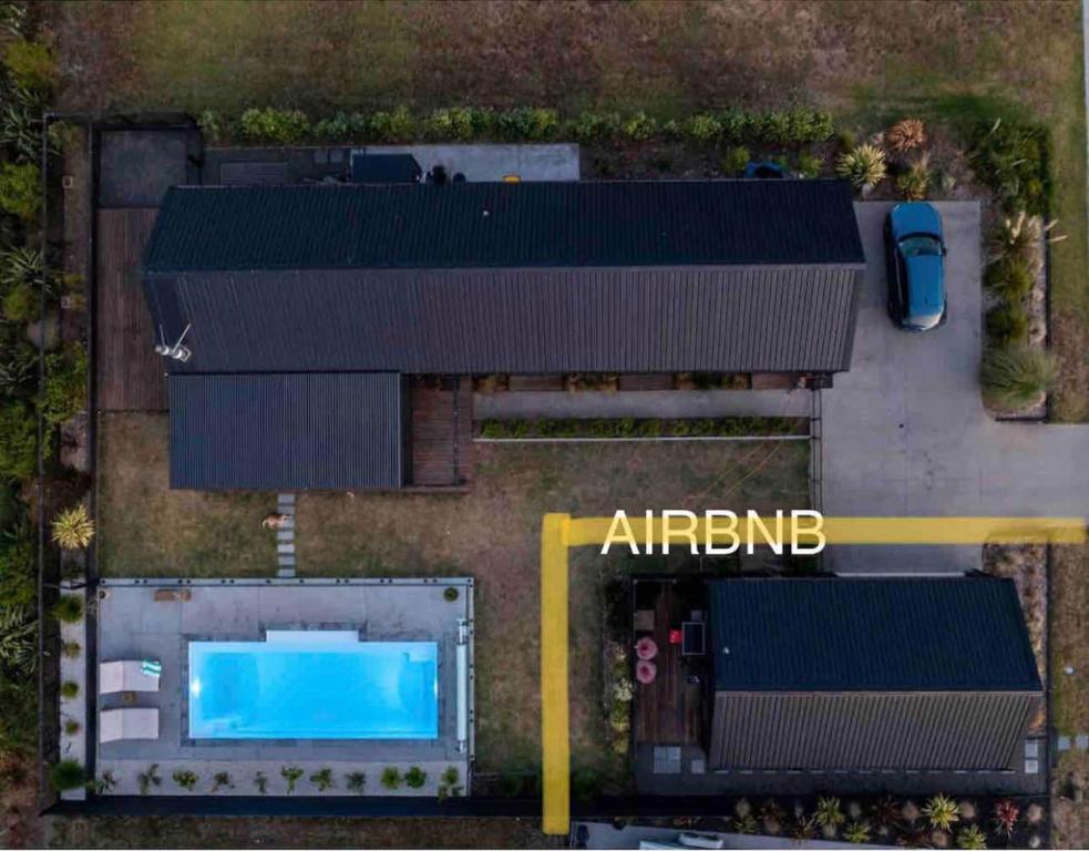 an overhead view of a building with a swimming pool at Private by the beach in Whitianga