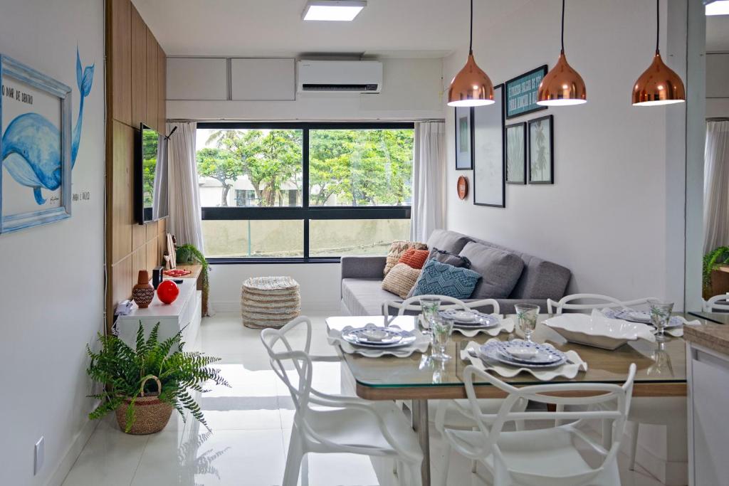 a kitchen and living room with a table and chairs at Apartamento Aconchegante Beira-Mar Ondina in Salvador