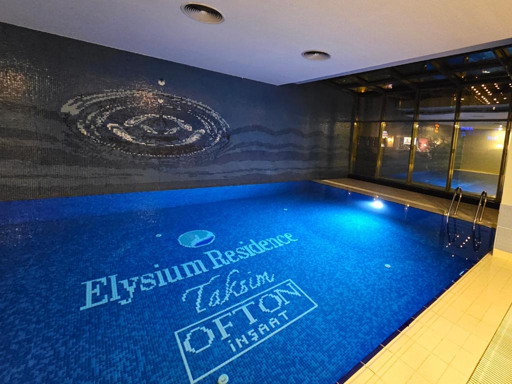 a swimming pool in a building with a sign on it at PERFECT RESİDENCE TAKSİM, 2 BEDROOM, POOL, Gym, Sauna in Istanbul