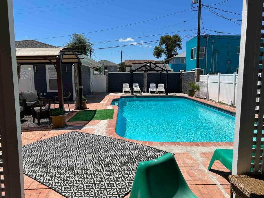 a swimming pool in a yard with chairs and a fence at Ocean View with Private Pool Casa de Joy Dos in Corpus Christi