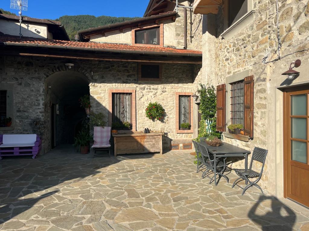 a patio of a house with a table and chairs at Al Buffardel in Bagnone