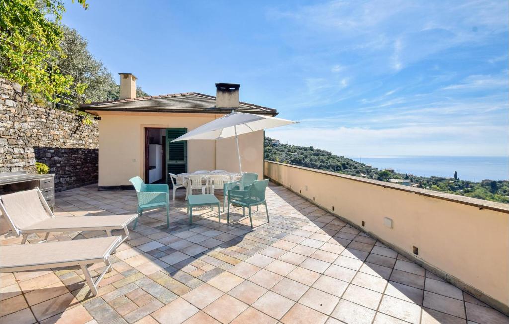 a patio with a table and chairs and an umbrella at Beautiful Home In Recco With Kitchen in Recco