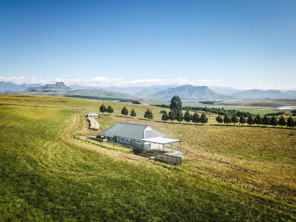 an overhead view of a house in a field at Dragons Landing Cottage in Underberg