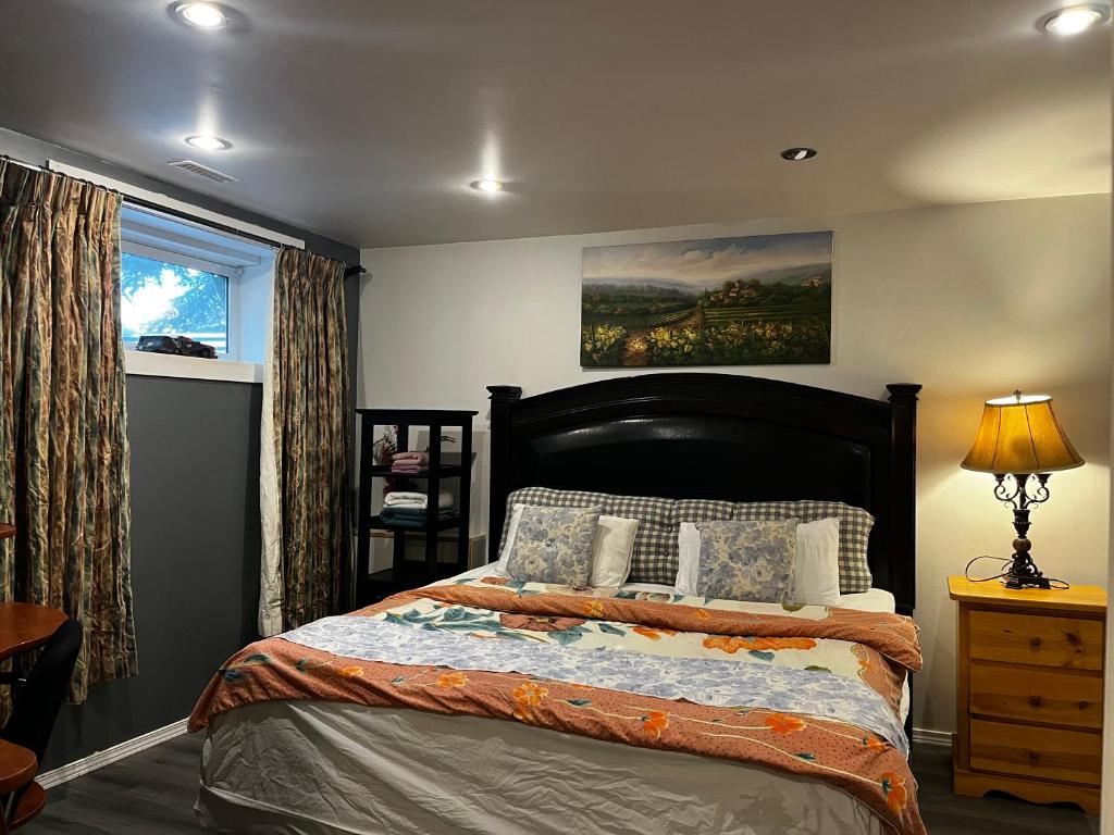 a bedroom with a bed and a painting on the wall at hidden valley new basement suite with private bathroom! in Calgary