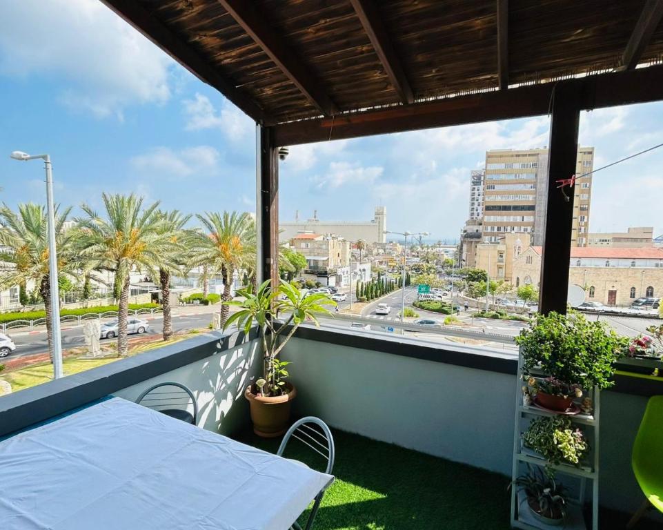a balcony with a table and a view of a city at EMAN SWEET HOME - cozy privet unique apartment in haifa downtown in Haifa