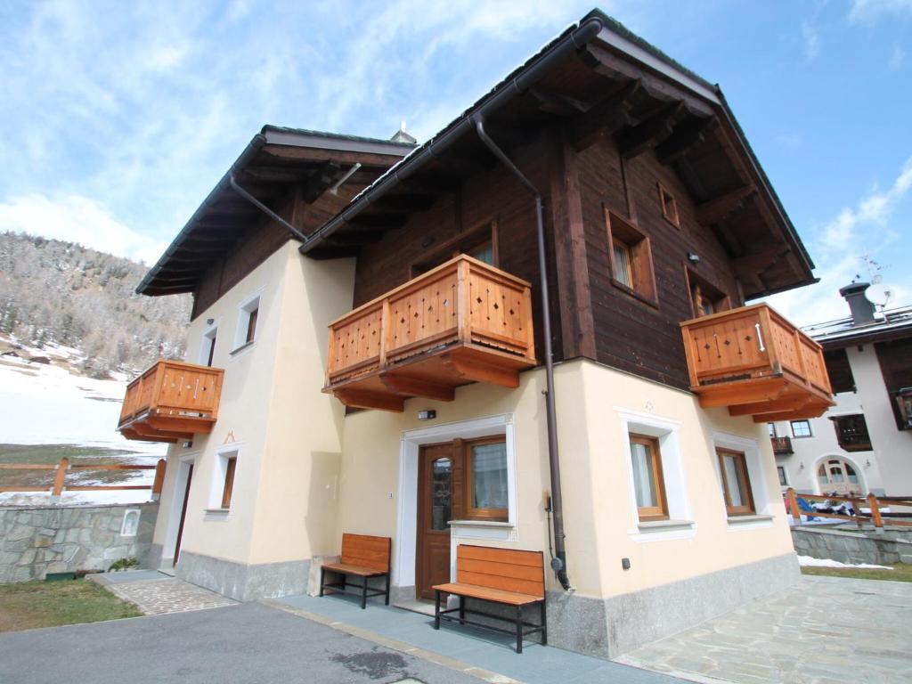 a building with wooden balconies on top of it at Stunning Holiday Home in Livigno near Ski Lift in Livigno