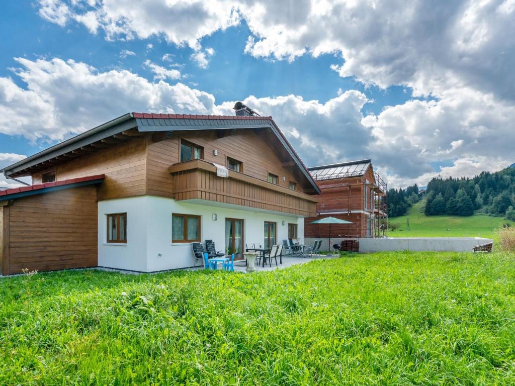 a house with a green field in front of it at Holiday home in ski area in Mittersill in Mittersill