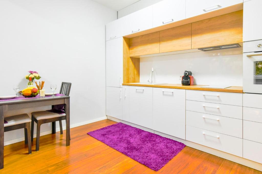 a kitchen with a table and a purple rug at Starflat National Theatre Park in Sofia