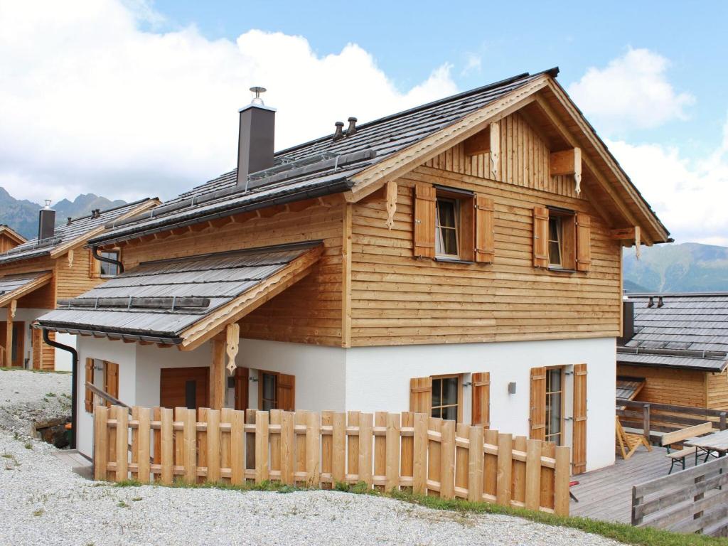 a house with solar panels on the roof at Cozy Chalet in Wei priach with Terrace in Weisspriach