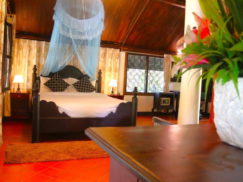 A bed or beds in a room at Namkhan View Luangprabang Resort