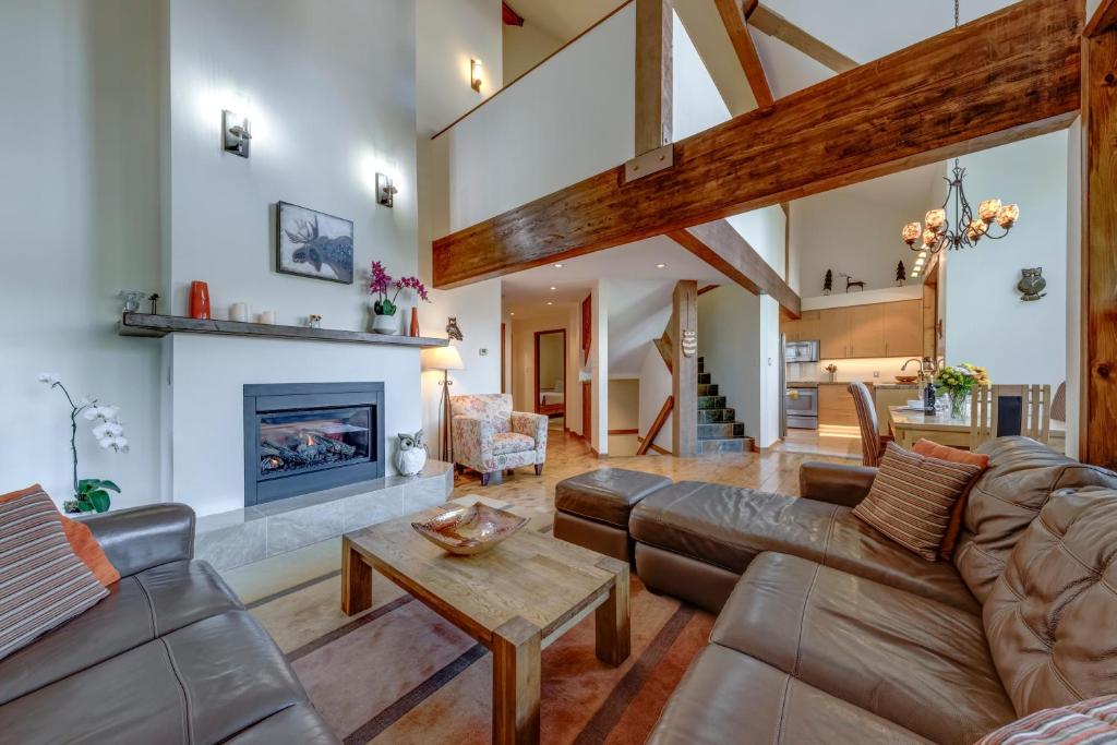 a living room with a couch and a fireplace at Northern Lights 21 in Whistler