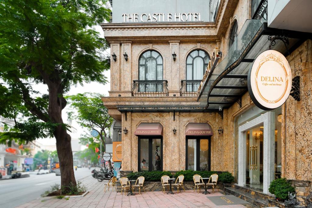 a building with chairs sitting outside of it at The Castle Hotel in Hanoi