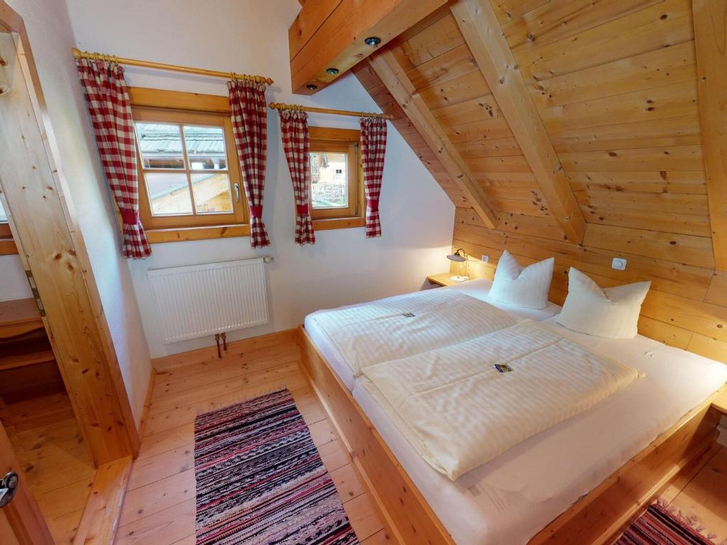 a bedroom with a large bed in a wooden house at Chalet in Neukirchen in Neukirchen am Großvenediger