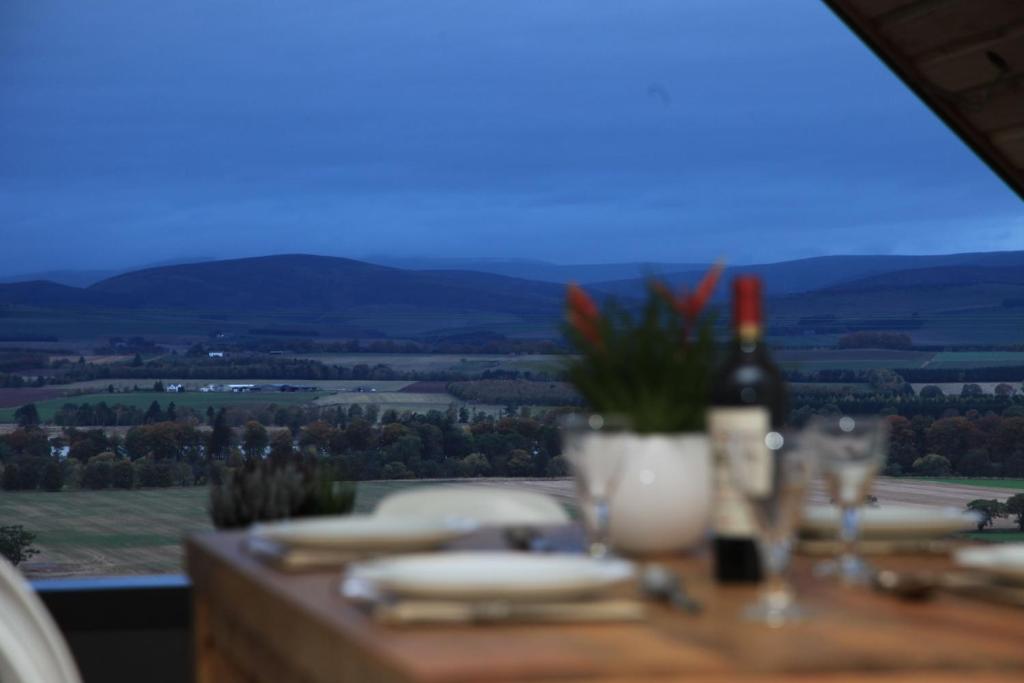 a table with a view of the countryside from a mountain at Isla in Forfar