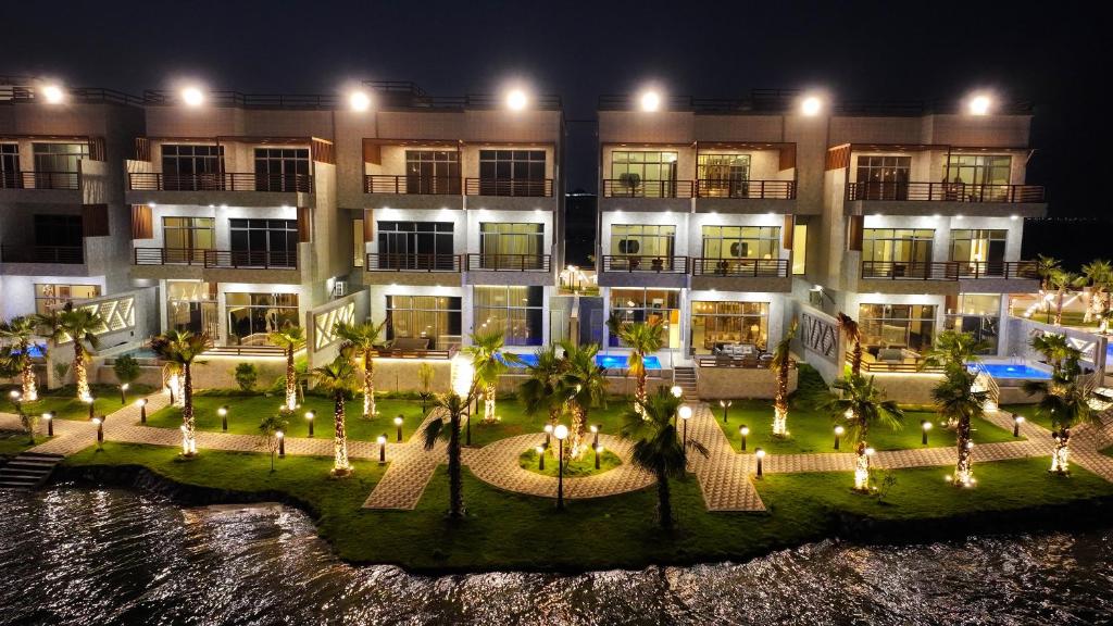 an aerial view of a hotel at night at منتجع اجمكان Ajmkan Resort in Al Khobar